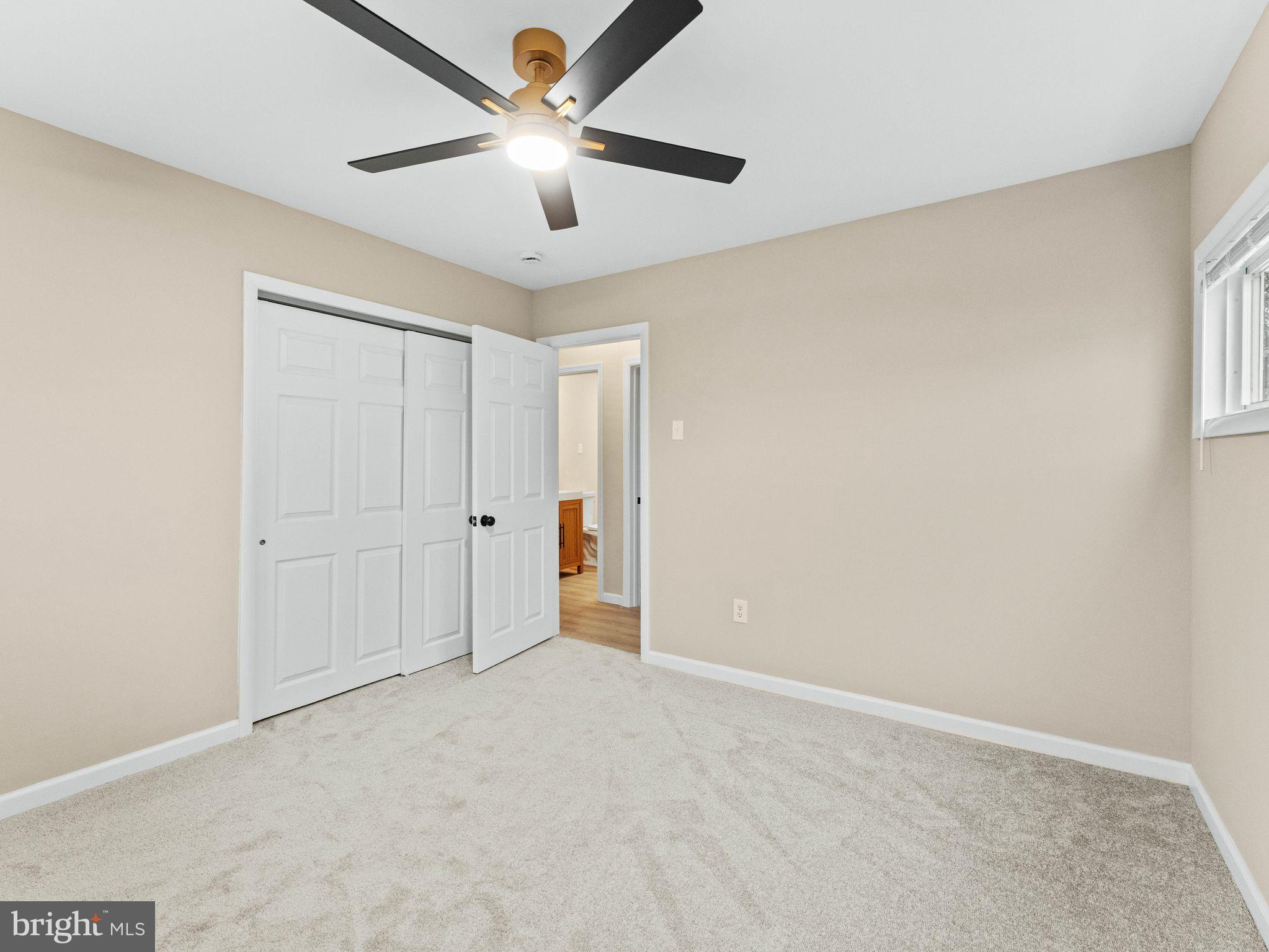 148 Lincoln Road Wenonah, NJ 08090 - Photo 20 of 40 an empty room with a ceiling fan and a window