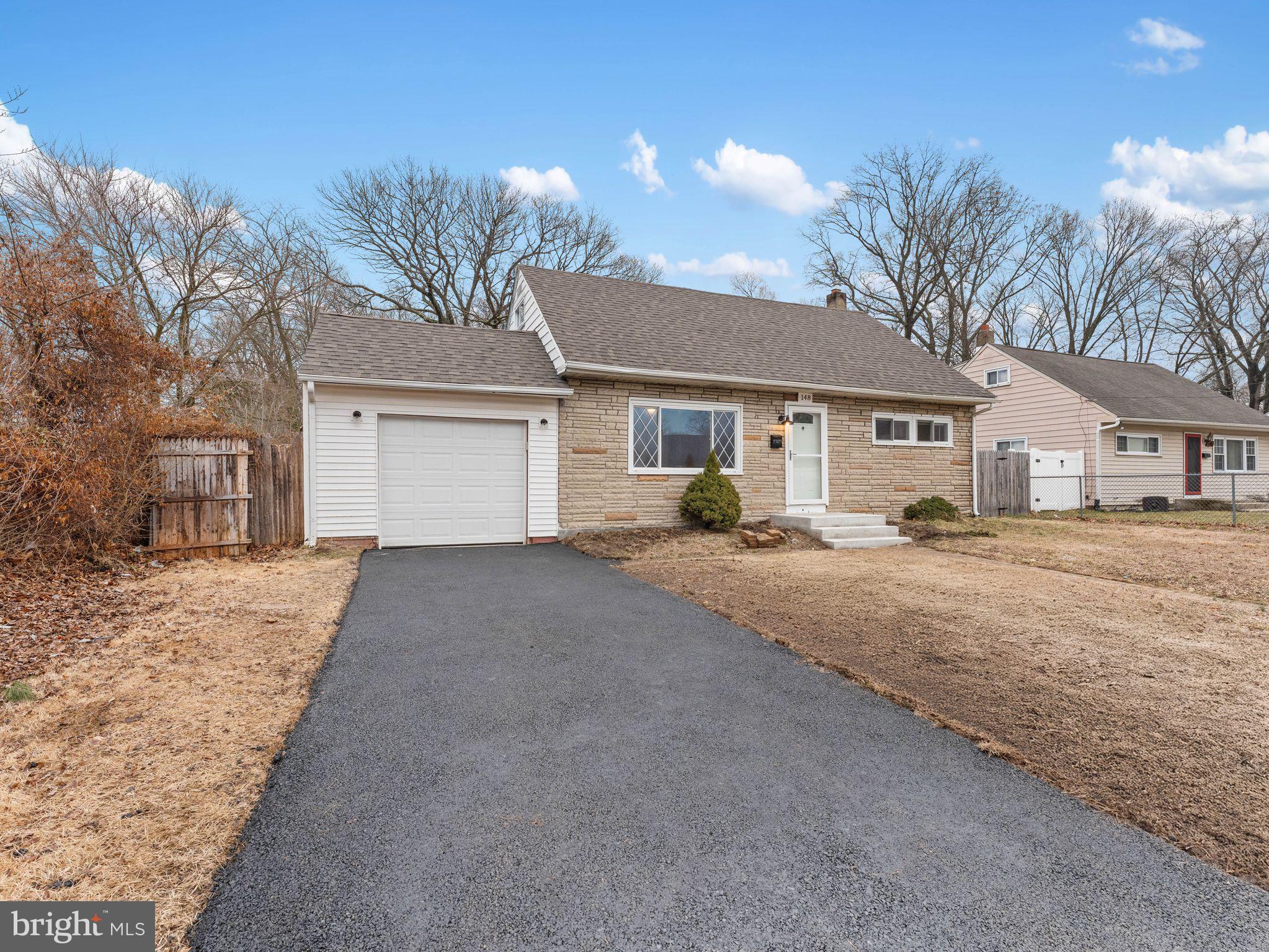 148 Lincoln Road Wenonah, NJ 08090 - Photo 2 of 40 a front view of a house with a yard and garage
