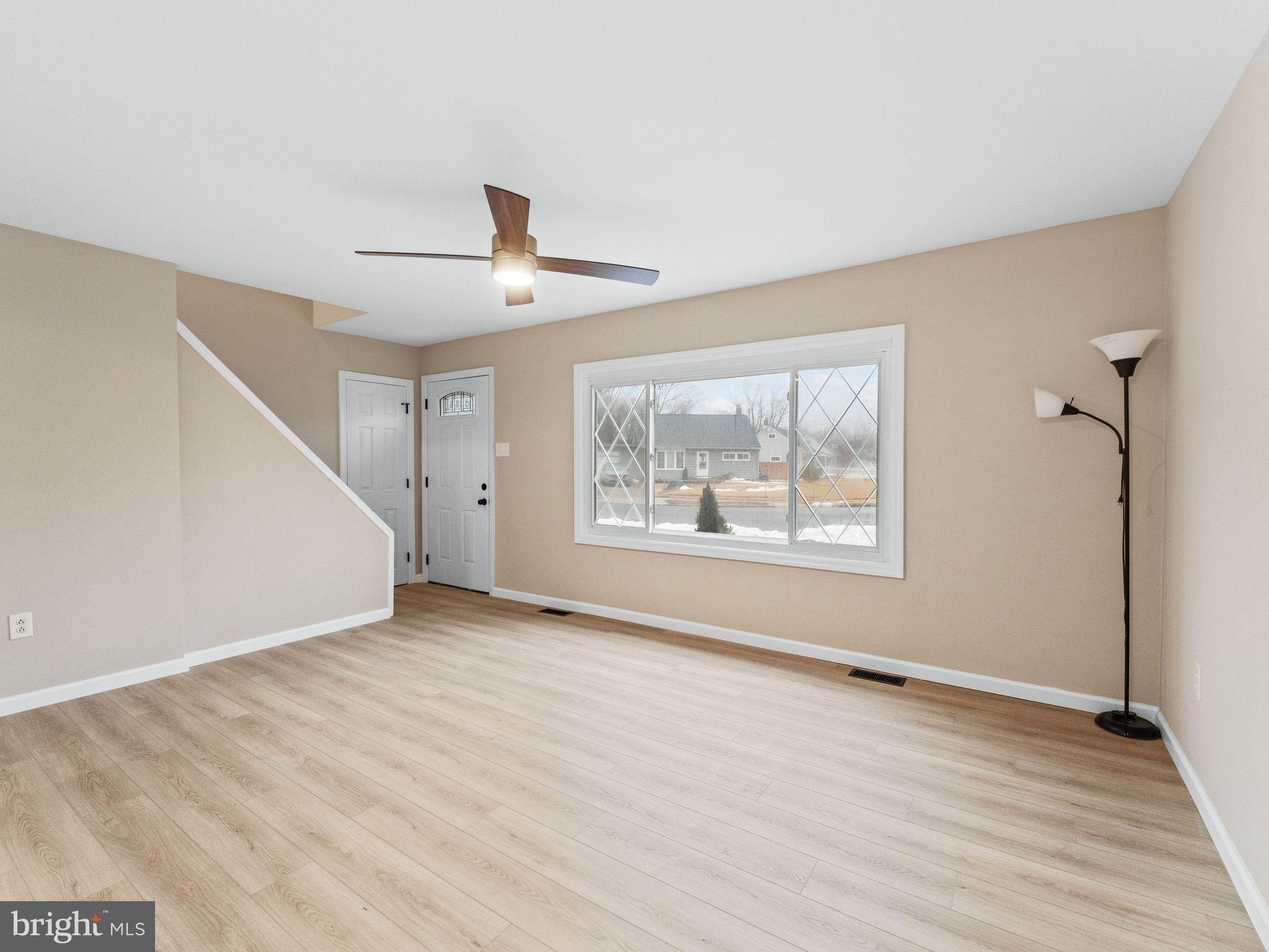 148 Lincoln Road Wenonah, NJ 08090 - Photo 7 of 40 a view of an empty room with a window and wooden floor