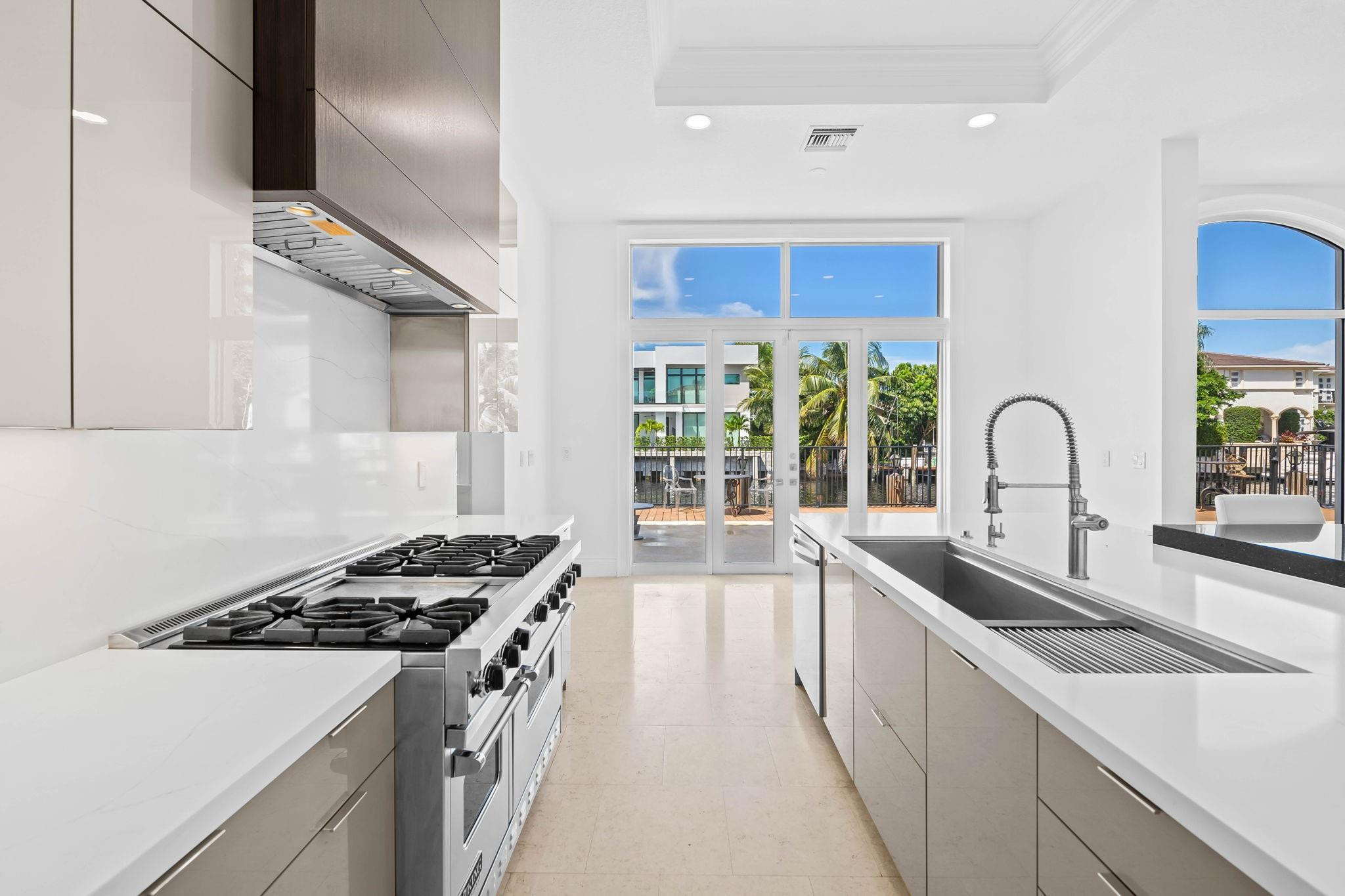861 Nafa Drive Boca Raton, FL 33487 - Photo 27 of 58 a kitchen with a sink and a stove top oven