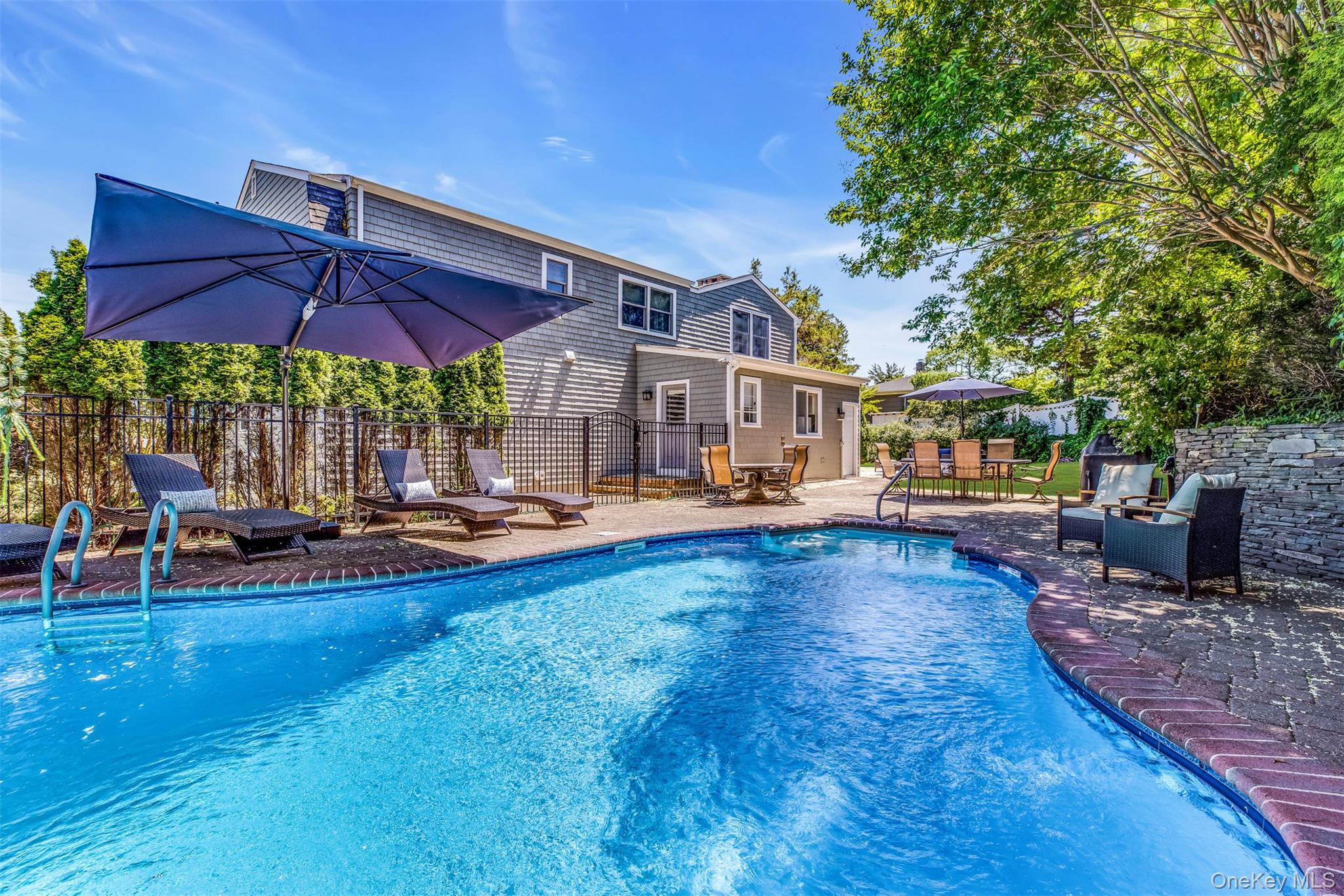 a swimming pool with outdoor seating yard and outdoor seating