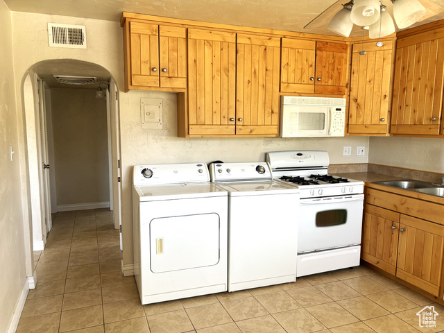 247 West 400 North, Unit 1 Moab, UT 84532 - Photo 10 of 27 Kitchen with white appliances, light tile patterned floors, arched walkways, and a ceiling fan