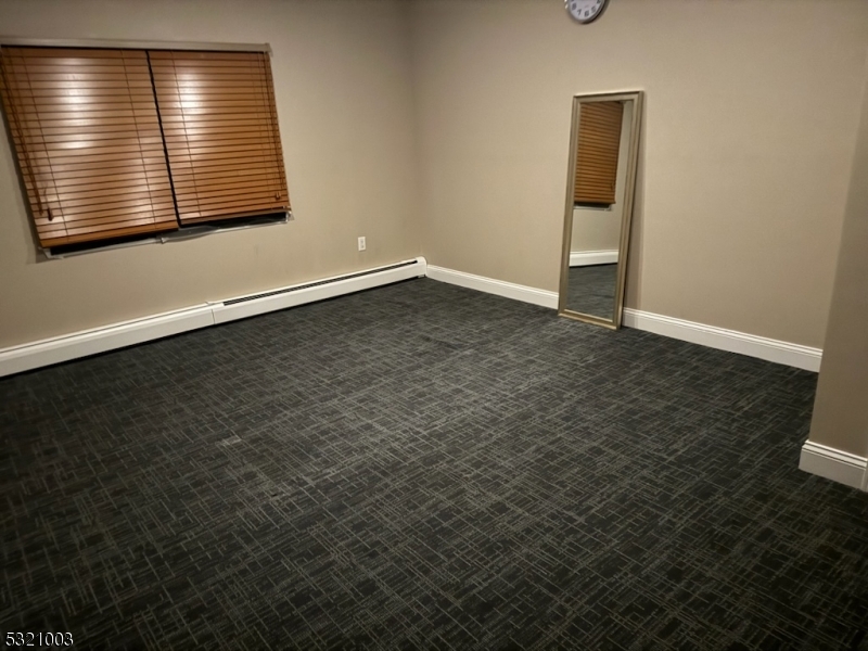 51 Main Street Succasunna, NJ 07876 - Photo 10 of 33 an empty room with wooden floor and windows