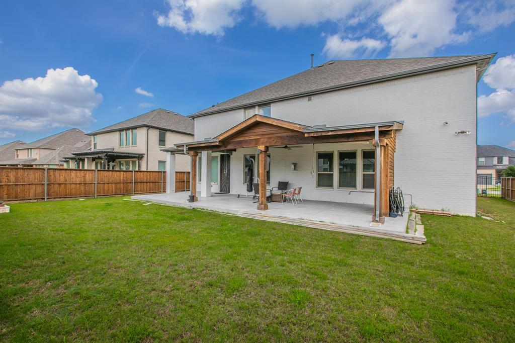 2521 Maidenhair Road Frisco, TX 75033 - Photo 38 of 39 Expansive rear yard featuring a large concrete patio with a wood pergola cover