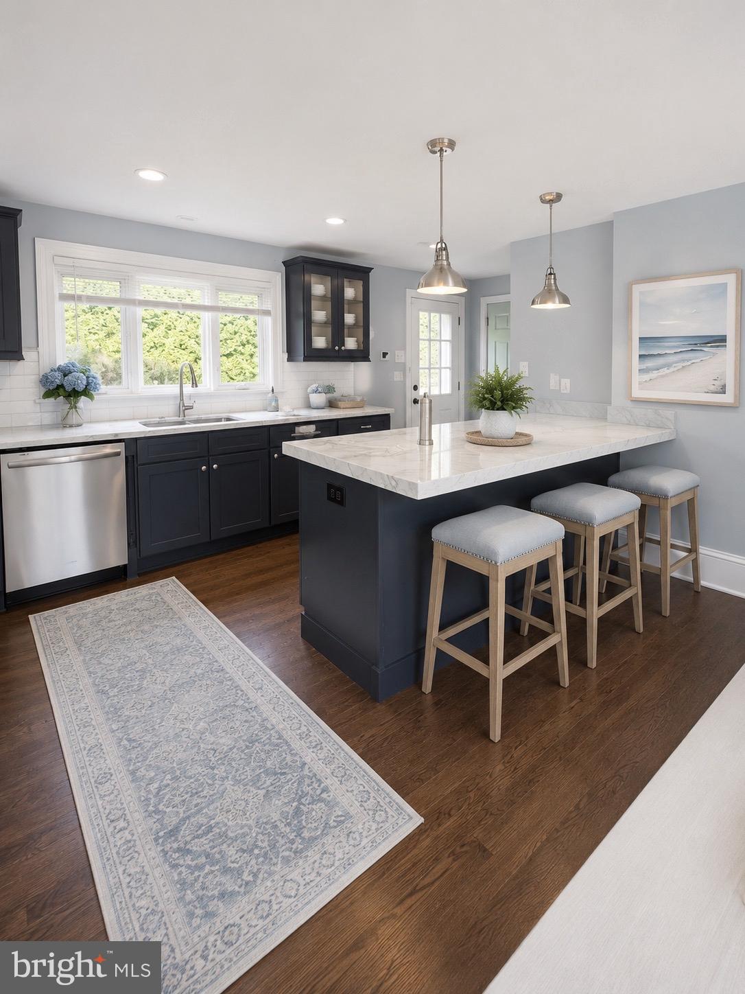 504 Conshohocken State Road Gladwyne, PA 19035 - Photo 2 of 20 a kitchen with a dining table chairs and sink