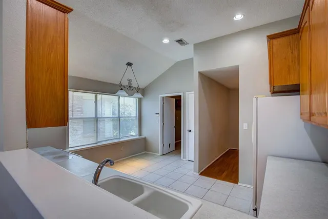 a room with pool table and windows