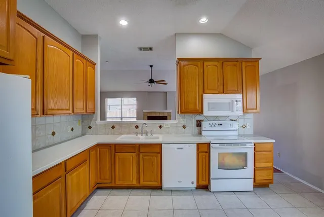a kitchen with a sink stove and cabinets