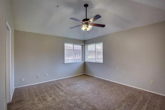 a view of a livingroom with a ceiling fan and window