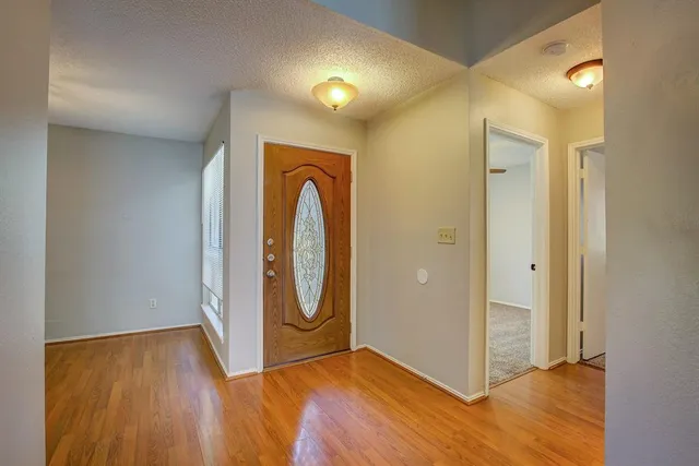 a view of a room with wooden floor and white walls