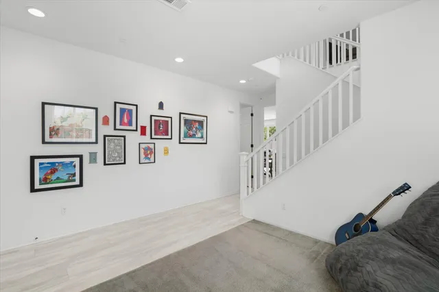 a living room with kitchen island furniture and a wooden floor