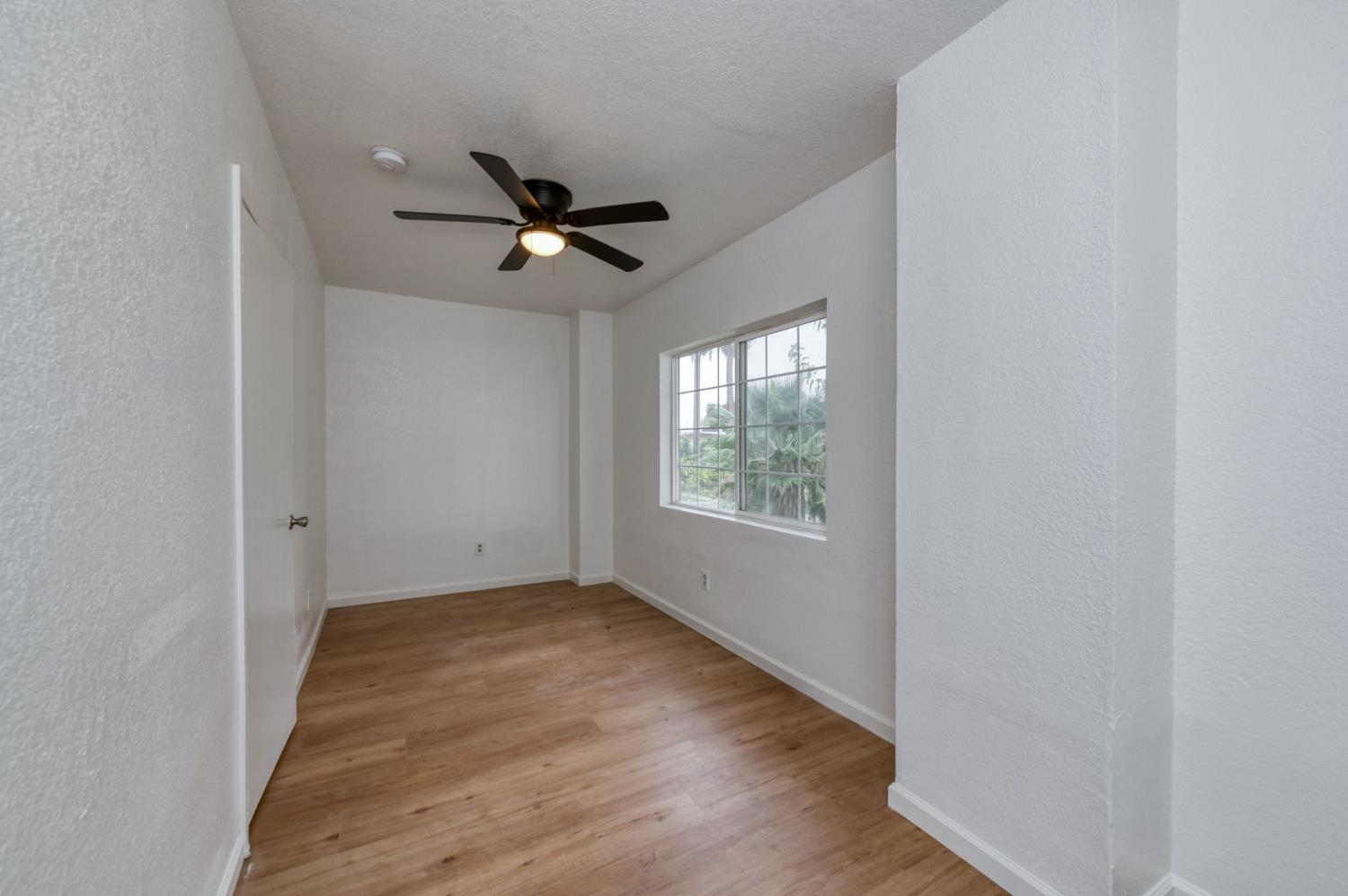 450 North Effie Street Fresno, CA 93701 - Photo 12 of 21 a view of empty room with wooden floor and fan