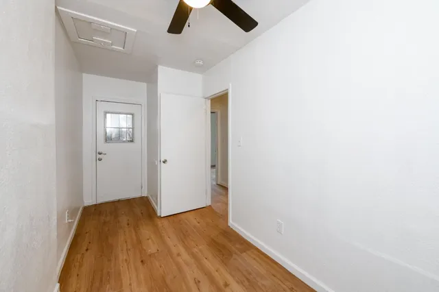 an empty room with closet and wooden floor