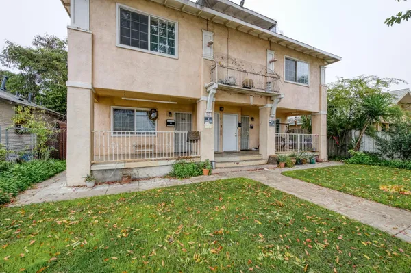 a front view of a house with a yard and outdoor seating