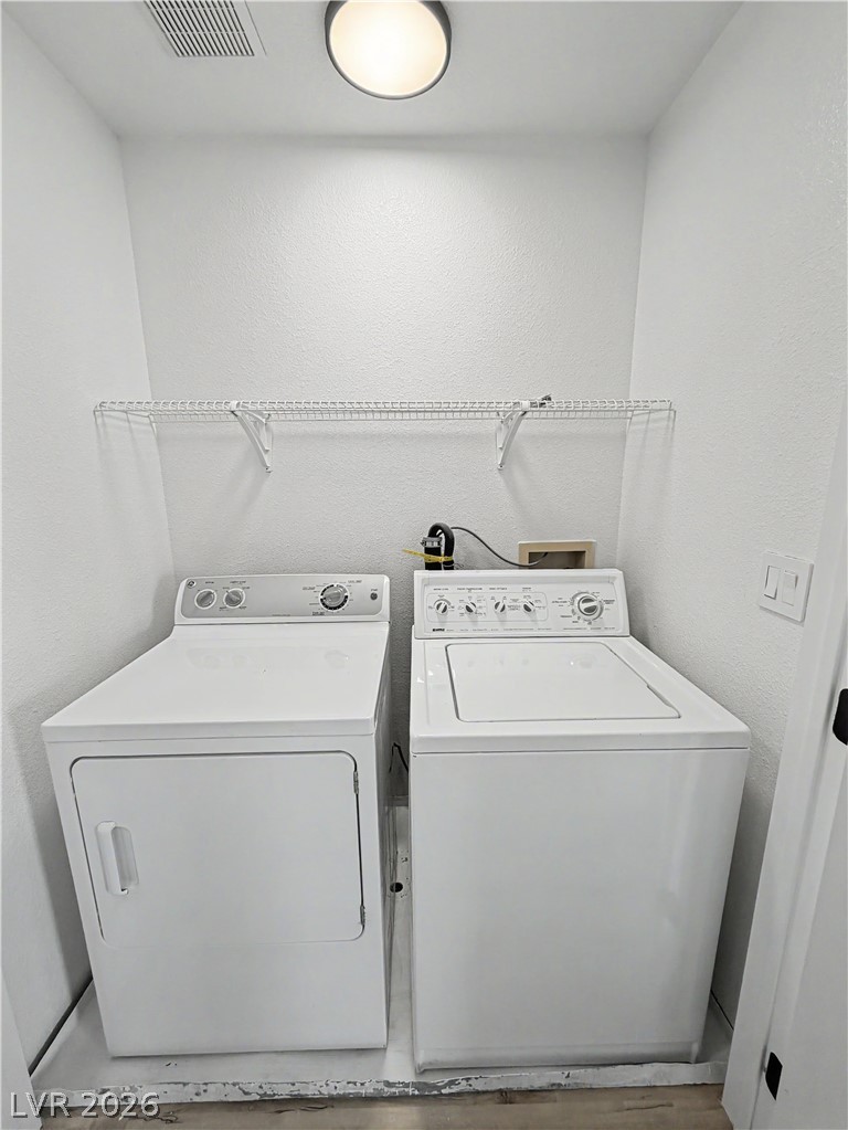 8977 Paige Rene Court Las Vegas, NV 89117 - Photo 23 of 31 Functional laundry space featuring a washer and dryer for everyday convenience.