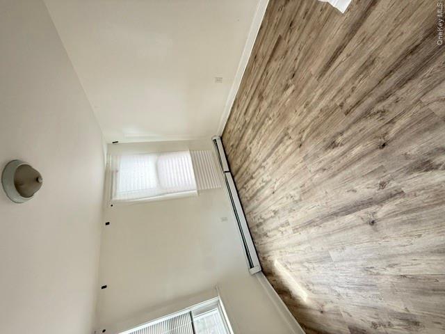 72 Chauncey Avenue New Rochelle, NY 10801 - Photo 9 of 14 an empty room with wooden floor and windows