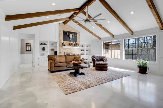 a living room with furniture and wooden floor