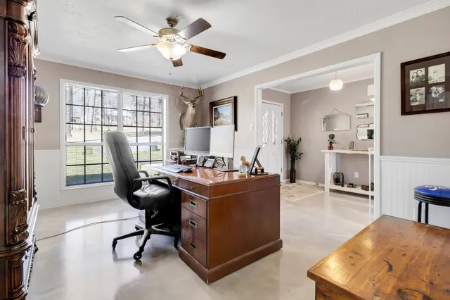 a work room with furniture and a flat screen tv
