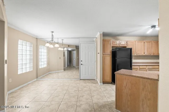 a view of a kitchen with refrigerator and an oven