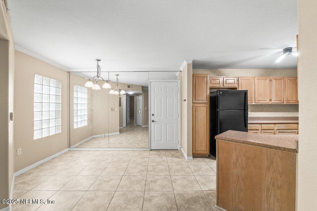 10150 Belle Rive Boulevard, Unit 303 Jacksonville, FL 32256 - Photo 13 of 23 a view of a kitchen with refrigerator and an oven