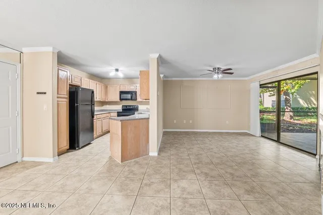 a view of kitchen with refrigerator and window