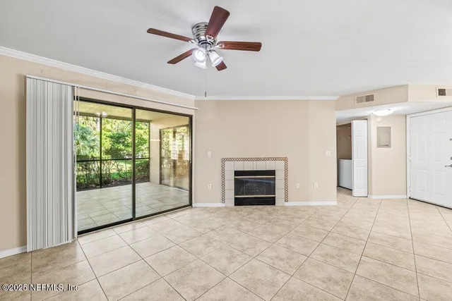 a view of empty room with a fireplace and a large window