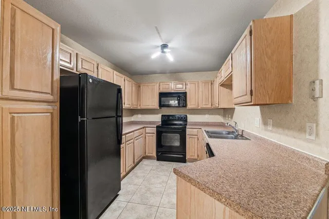 a kitchen with stainless steel appliances granite countertop a refrigerator stove and oven