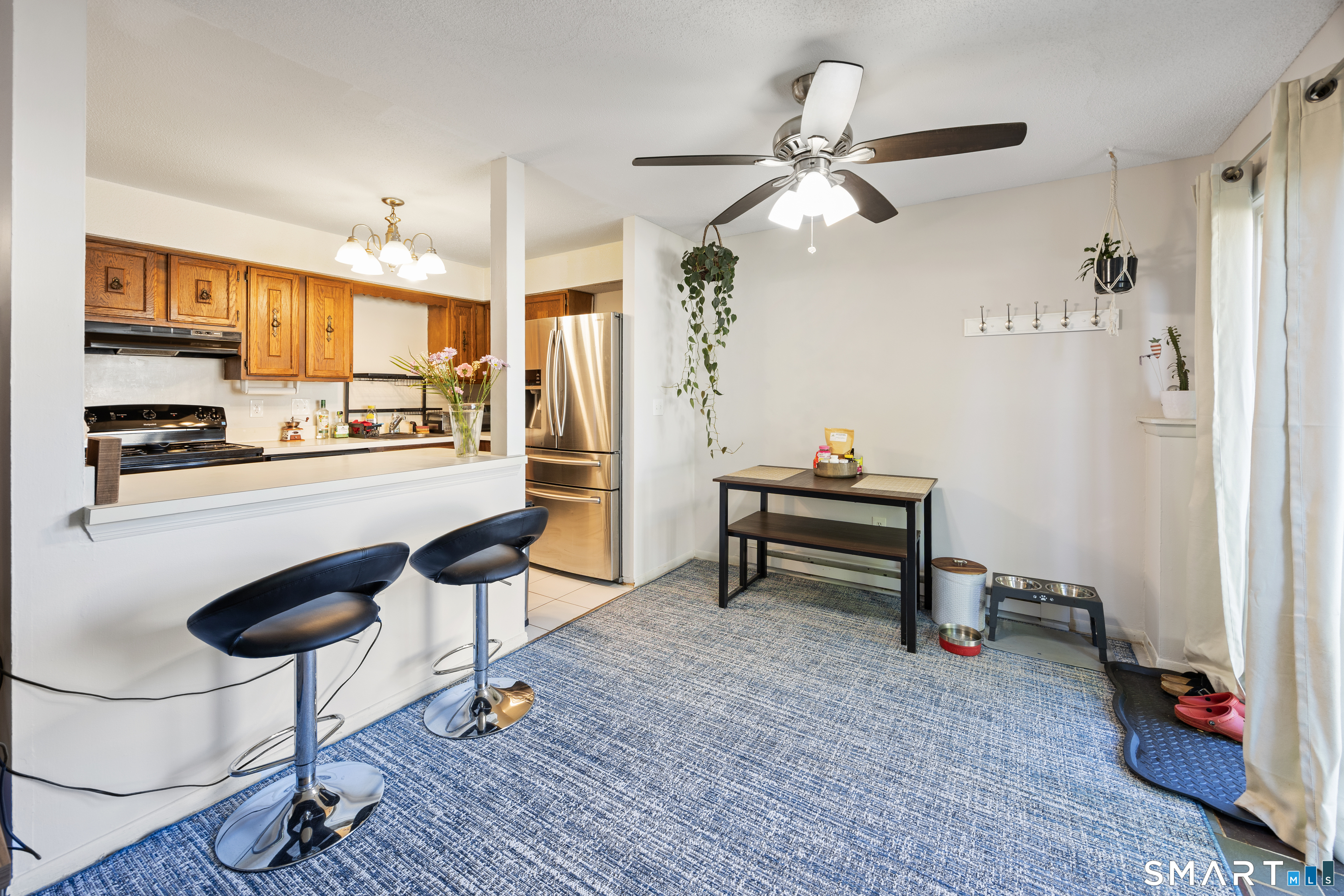 560 Yale Avenue, Unit 82 Meriden, CT 06450 - Photo 8 of 22 a living room with furniture and a kitchen view