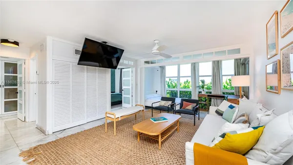 a living room with furniture wooden floor and a flat screen tv