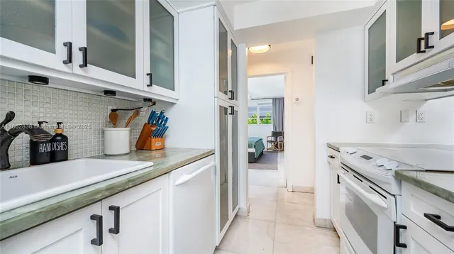 a kitchen with stainless steel appliances granite countertop a sink and cabinets
