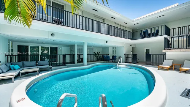 a swimming pool with outdoor seating and yard