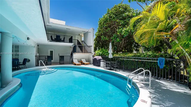 a house view with a swimming pool and sitting space
