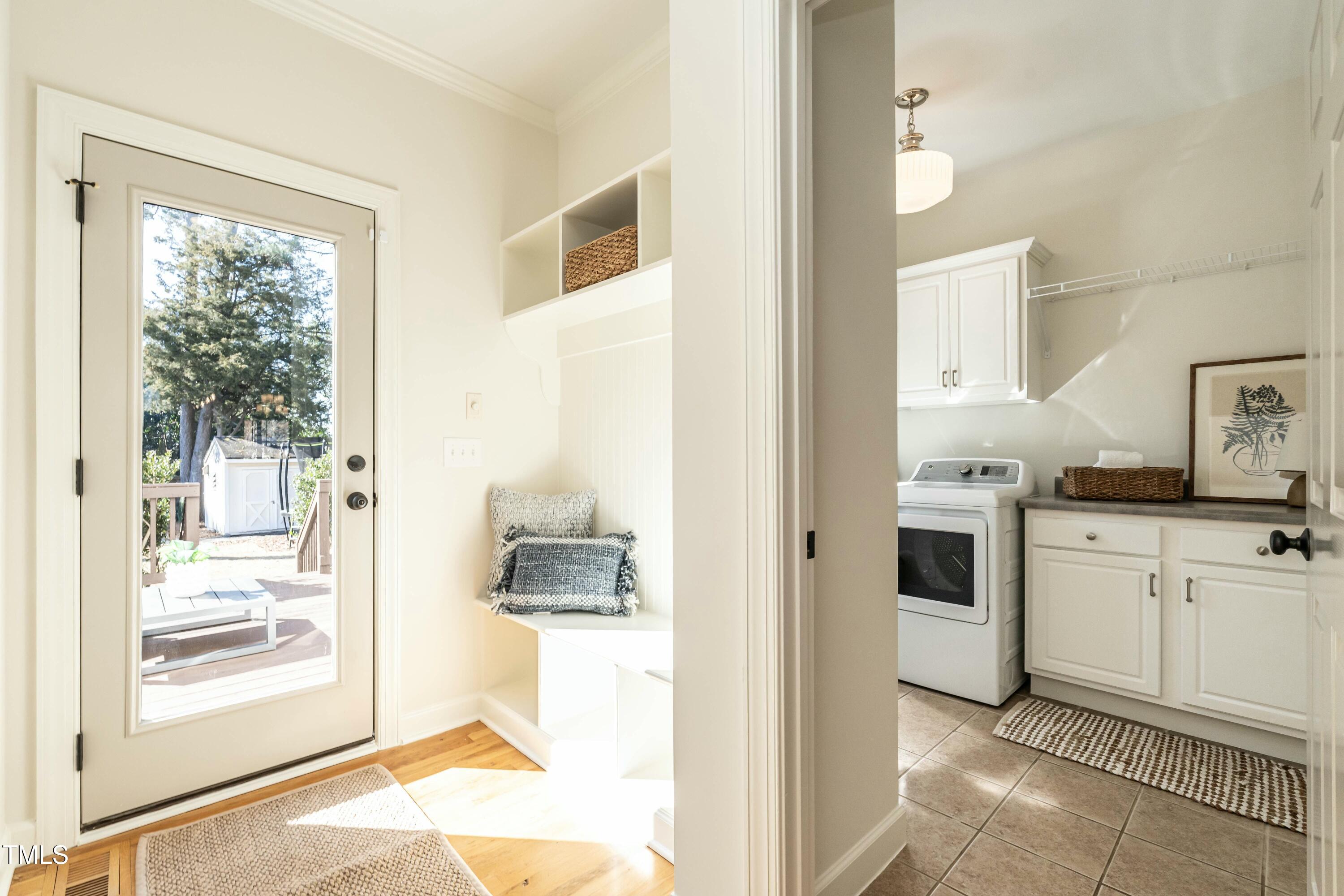 708 Kimbrough Street Raleigh, NC 27608 - Photo 16 of 36 a kitchen with a refrigerator and white cabinets