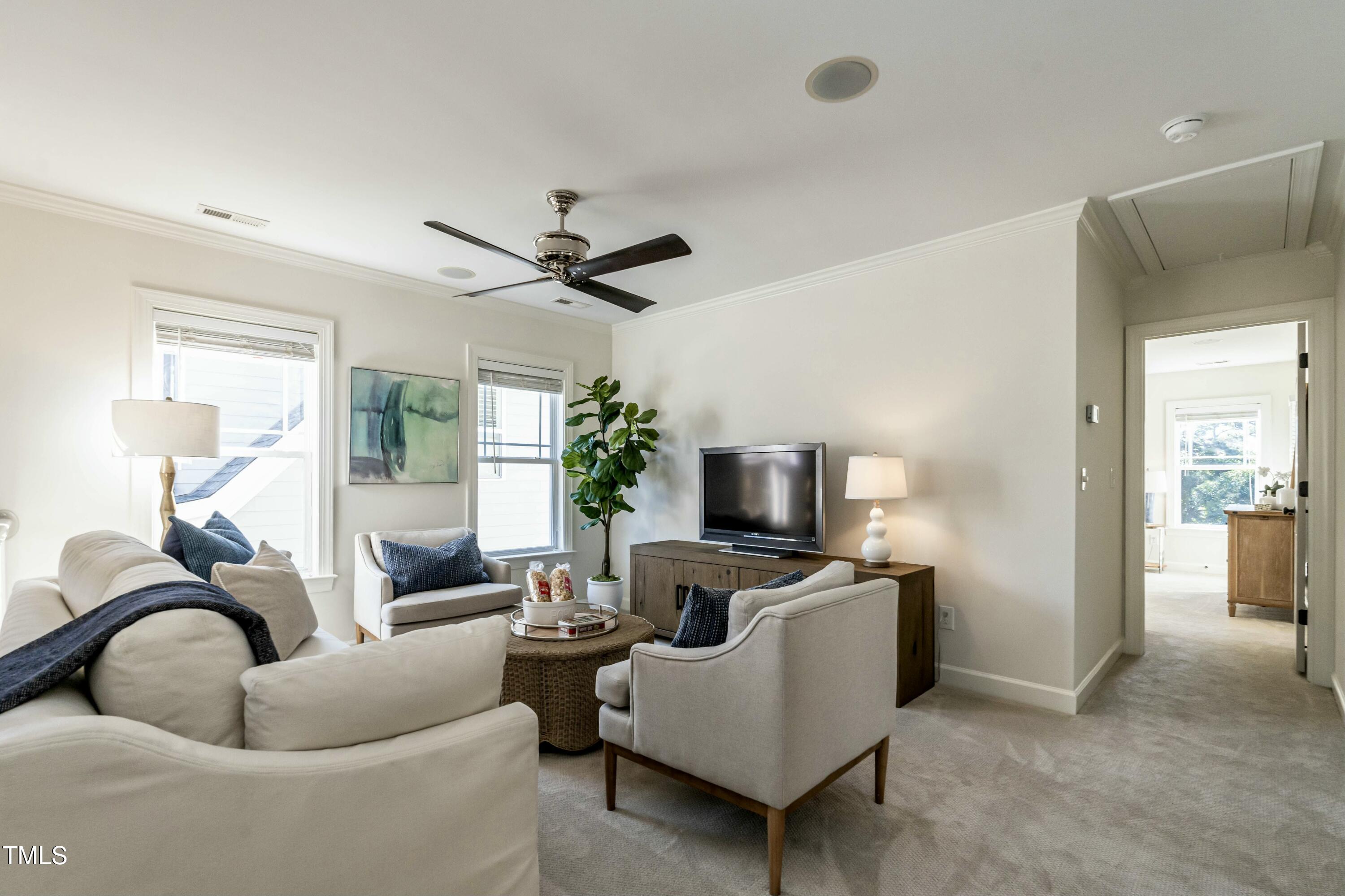 708 Kimbrough Street Raleigh, NC 27608 - Photo 17 of 36 a living room with furniture a fireplace and a flat screen tv