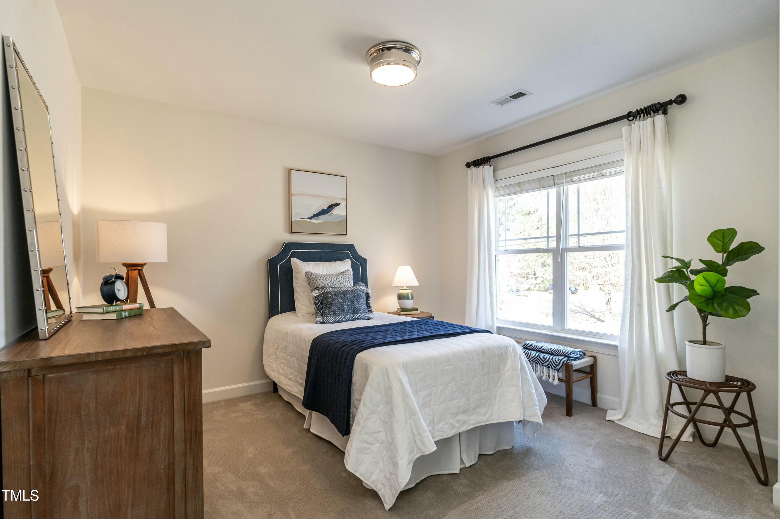 708 Kimbrough Street Raleigh, NC 27608 - Photo 25 of 36 a bedroom with a bed and window