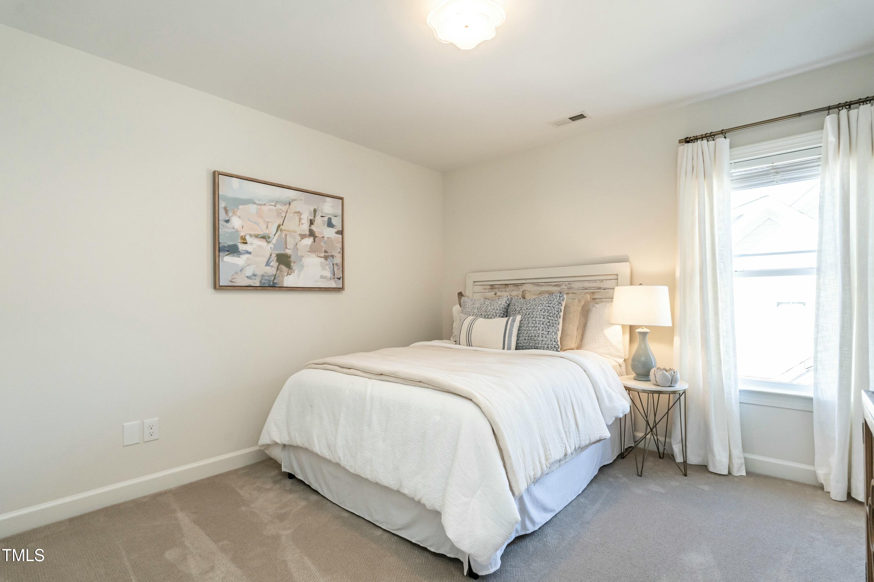 708 Kimbrough Street Raleigh, NC 27608 - Photo 27 of 36 a bedroom with a bed and a window