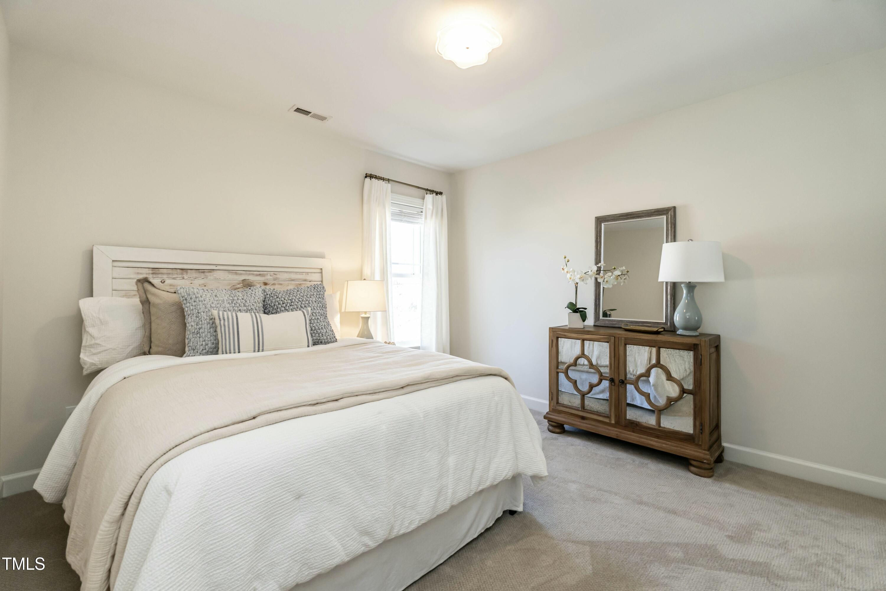 708 Kimbrough Street Raleigh, NC 27608 - Photo 28 of 36 a bedroom with a bed and a window