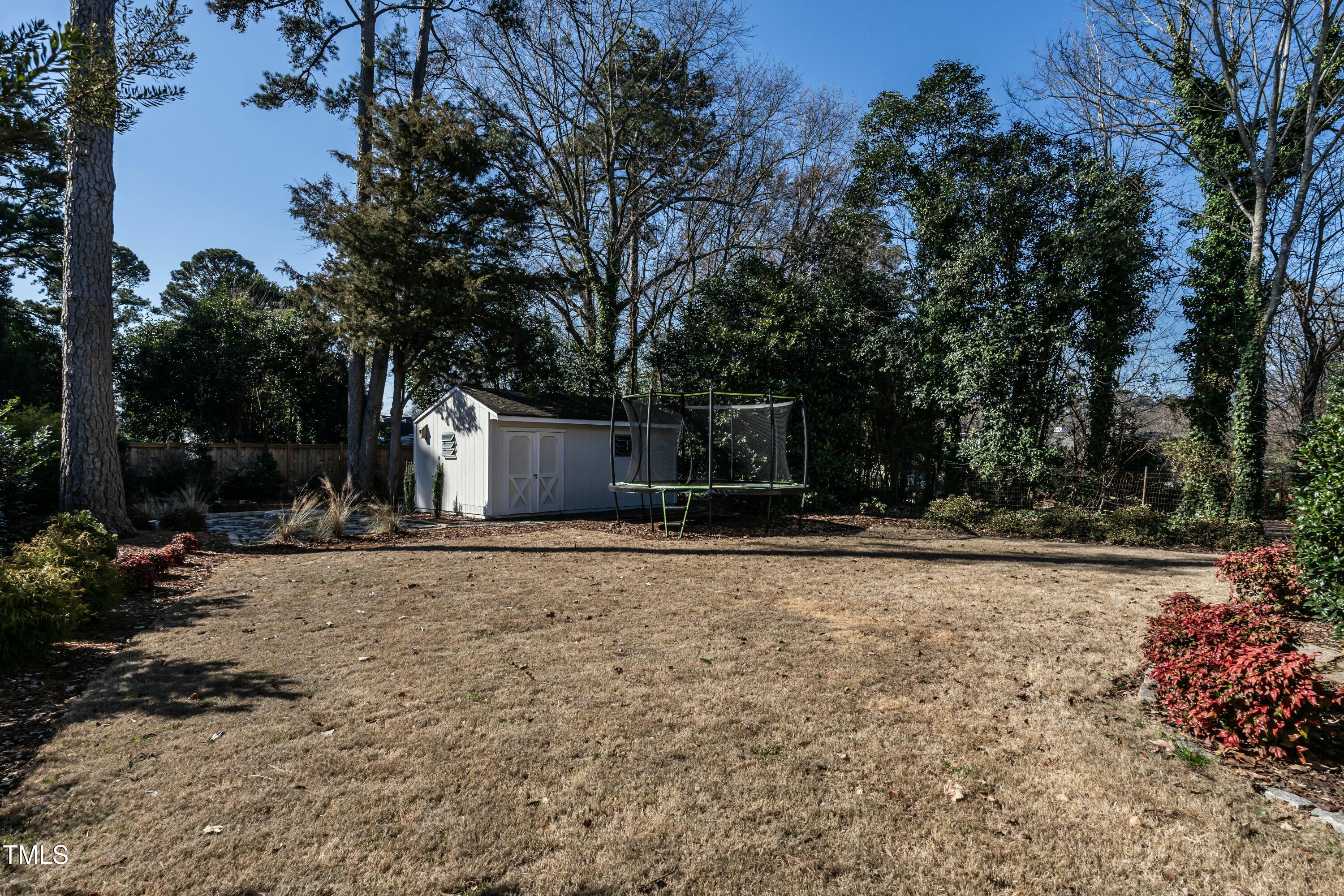 708 Kimbrough Street Raleigh, NC 27608 - Photo 30 of 36 a front view of a house with garden and trees