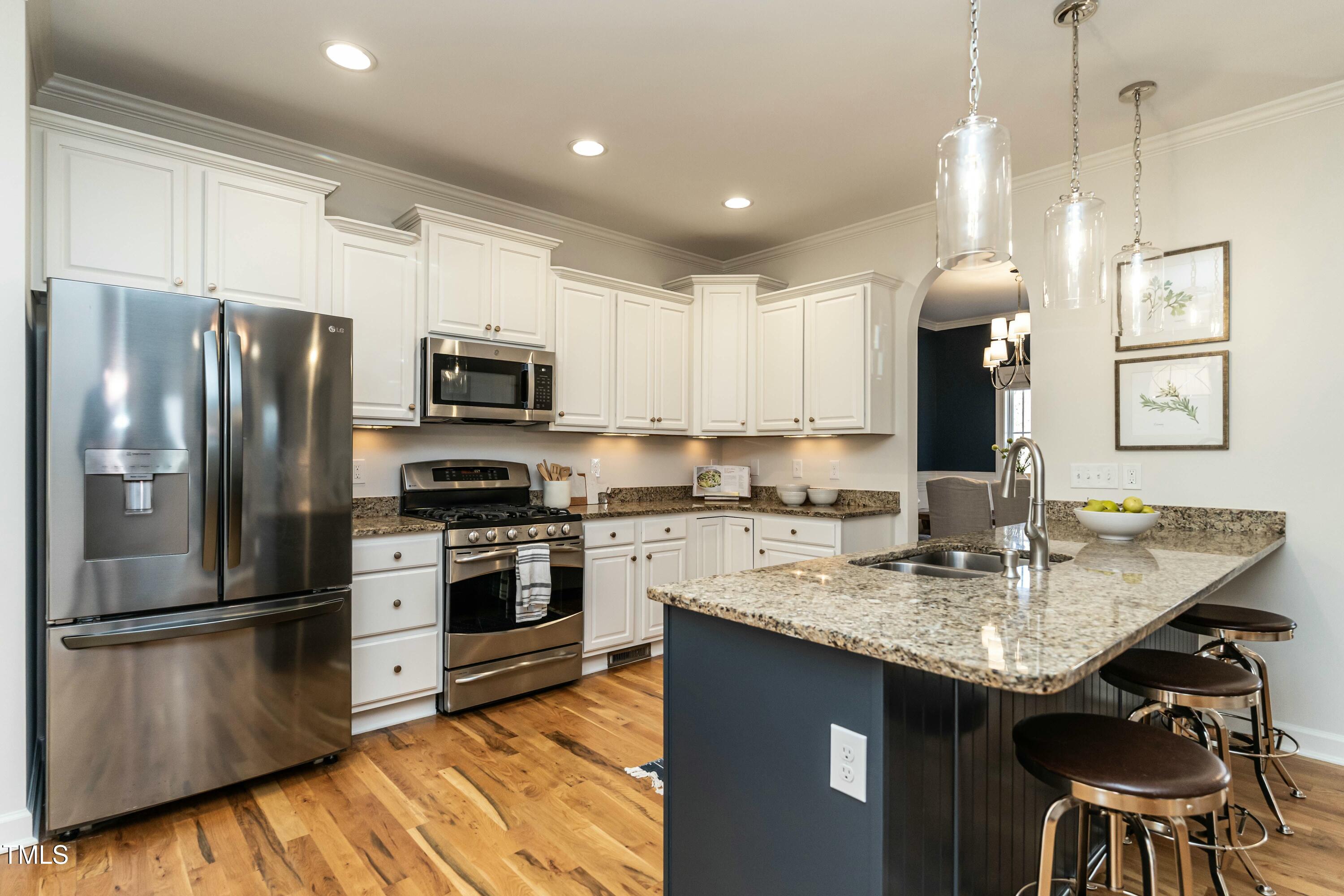 708 Kimbrough Street Raleigh, NC 27608 - Photo 5 of 36 a kitchen with stainless steel appliances granite countertop a sink refrigerator and microwave