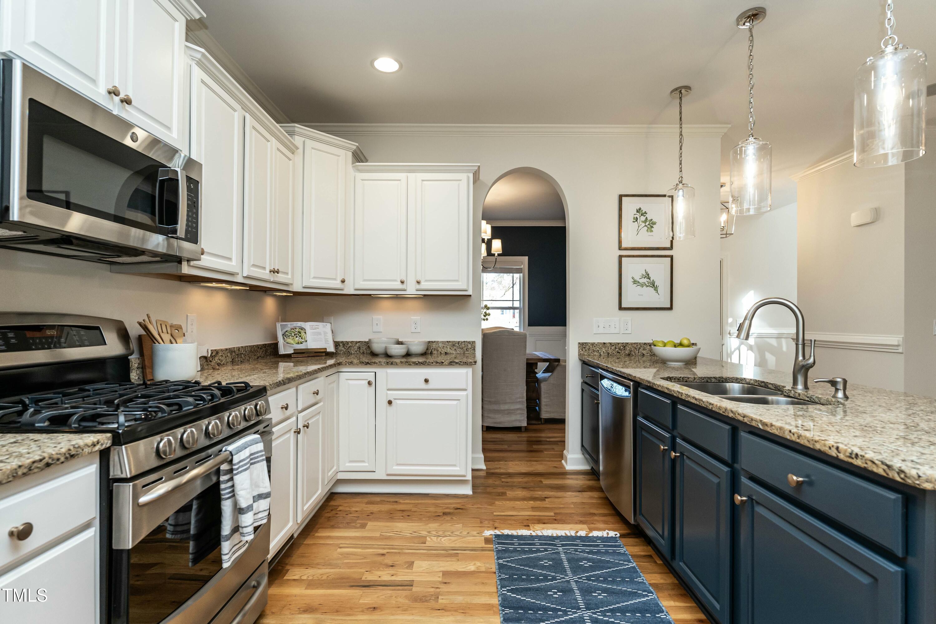 708 Kimbrough Street Raleigh, NC 27608 - Photo 6 of 36 a kitchen with stainless steel appliances granite countertop a sink stove and microwave