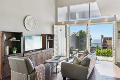 a living room with furniture a lamp and a large window