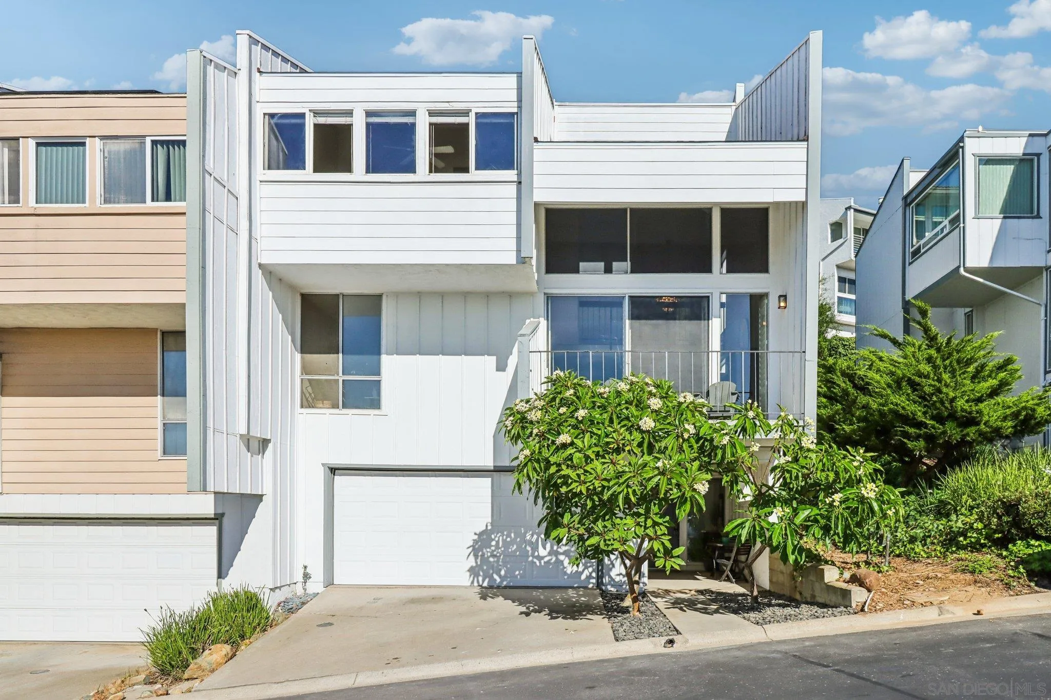 6329 Caminito Estrellado San Diego, CA 92120 - Photo 17 of 61 a front view of a house with a yard and garage