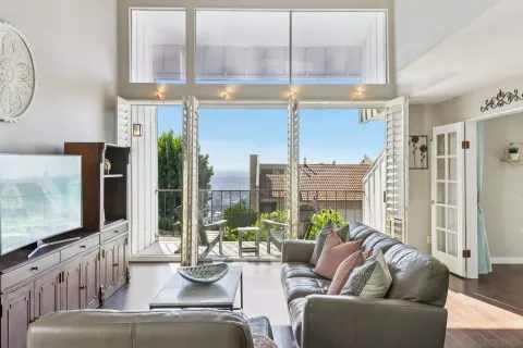 a living room with furniture large window and flat screen tv