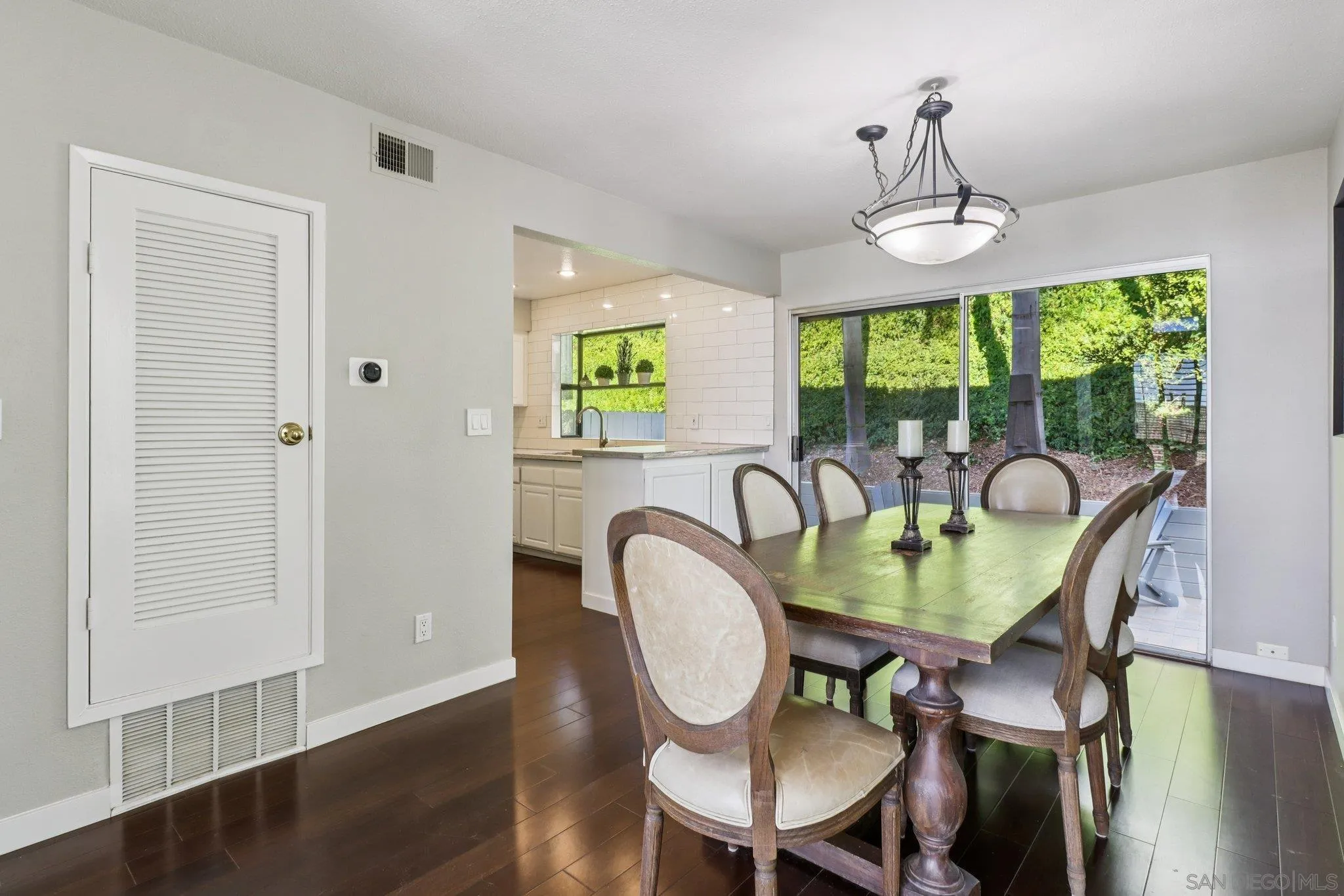 6329 Caminito Estrellado San Diego, CA 92120 - Photo 26 of 61 a view of a dining room with furniture a chandelier and wooden floor