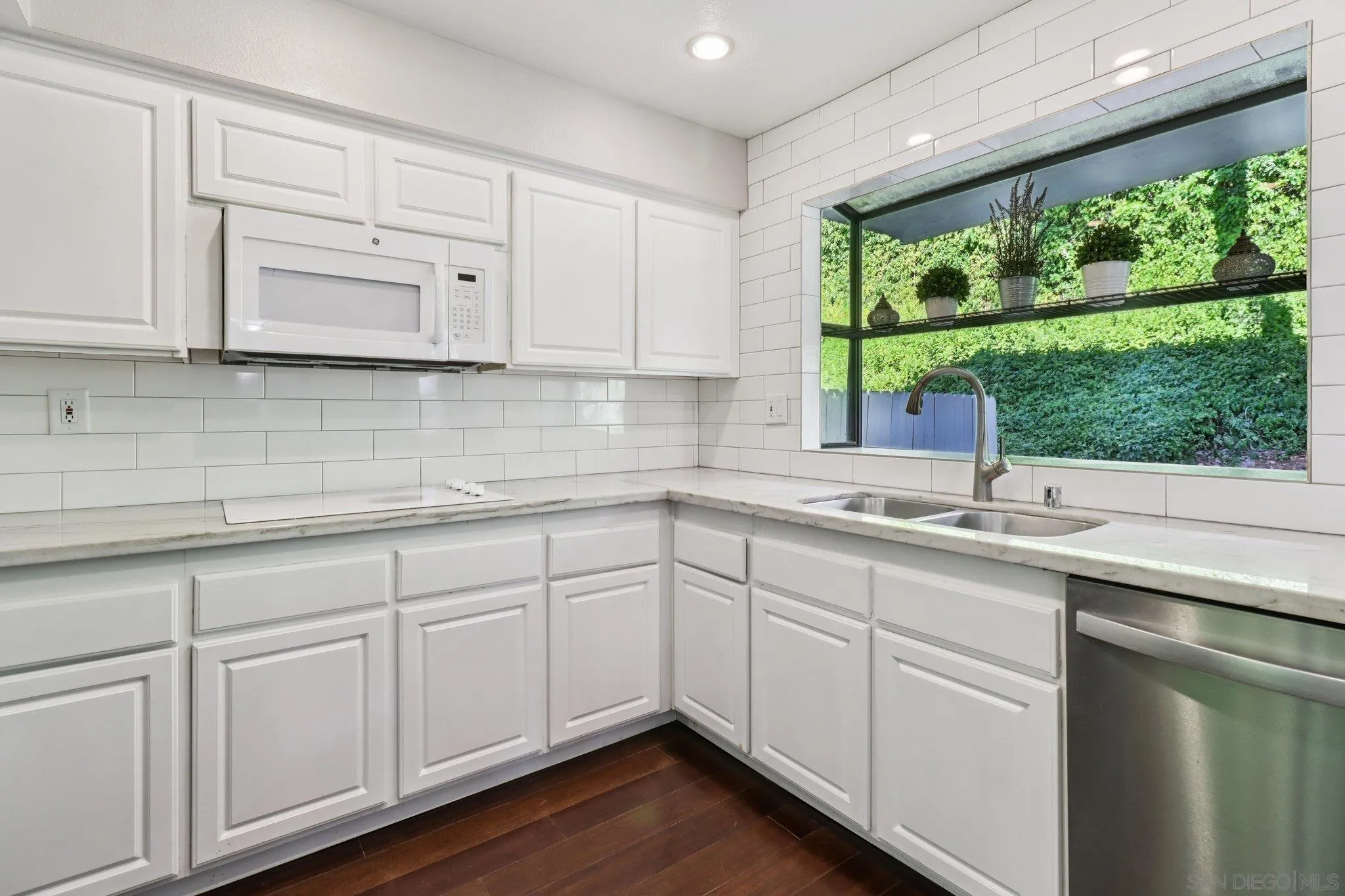 6329 Caminito Estrellado San Diego, CA 92120 - Photo 28 of 61 a kitchen with white cabinets and sink