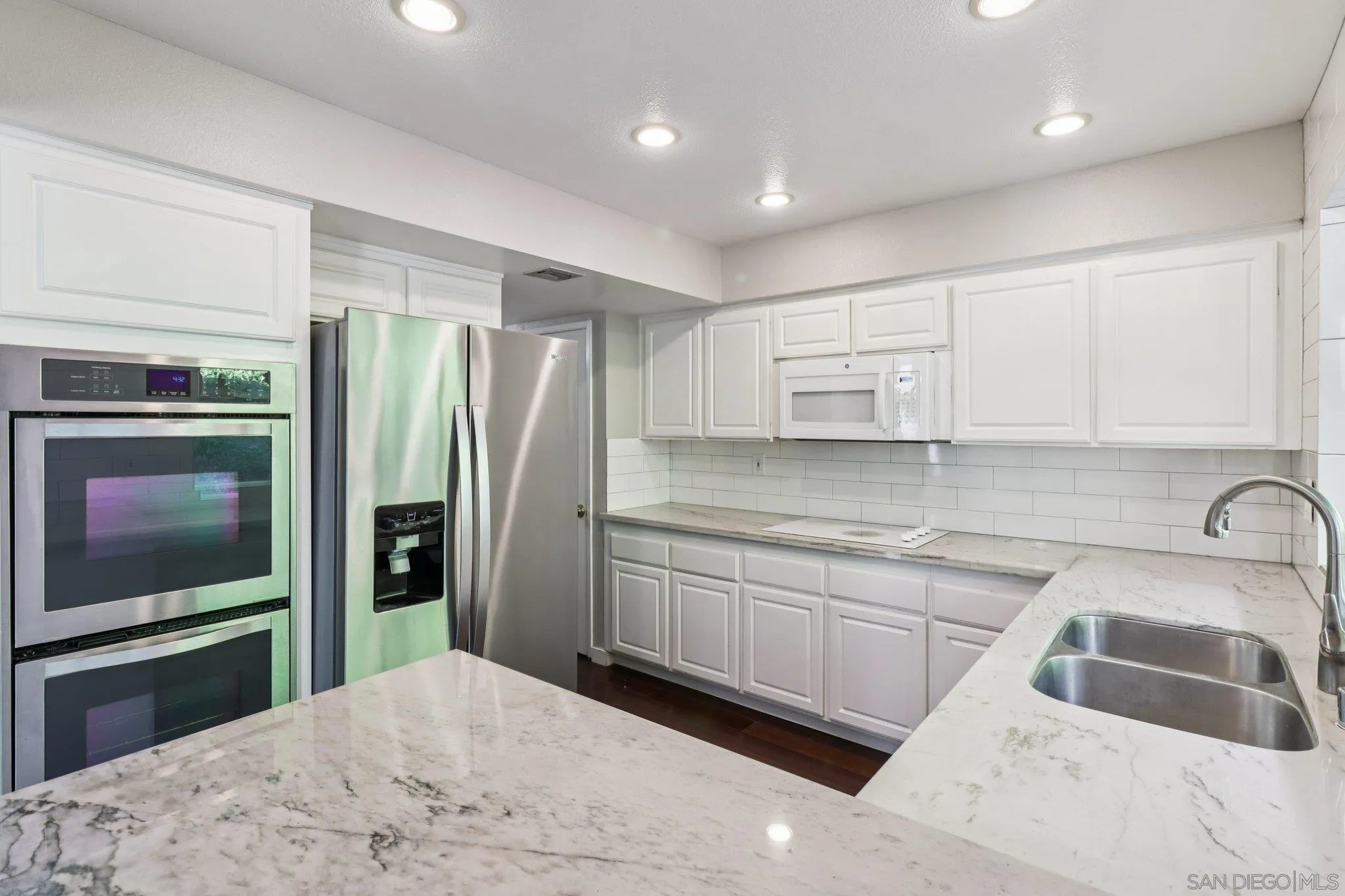 6329 Caminito Estrellado San Diego, CA 92120 - Photo 29 of 61 a kitchen with granite countertop a sink stainless steel appliances and cabinets