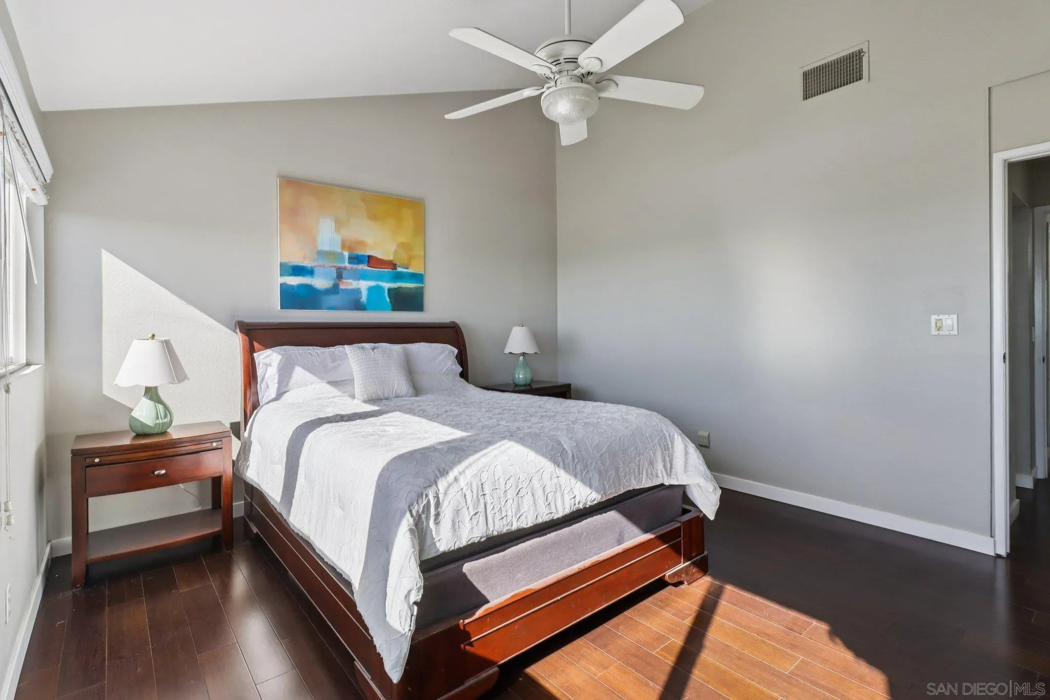 6329 Caminito Estrellado San Diego, CA 92120 - Photo 33 of 61 a bedroom with a bed and a chandelier