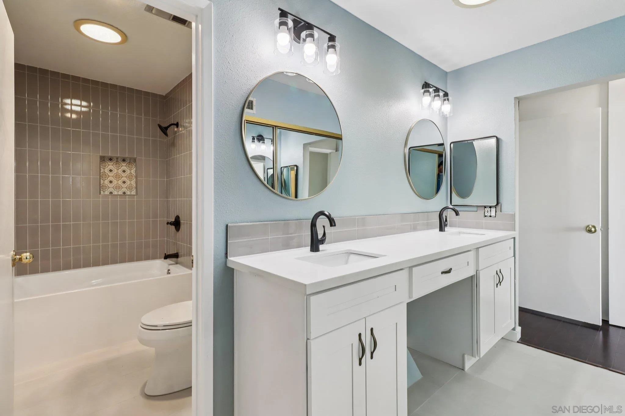 6329 Caminito Estrellado San Diego, CA 92120 - Photo 36 of 61 a bathroom with a toilet sink and mirror