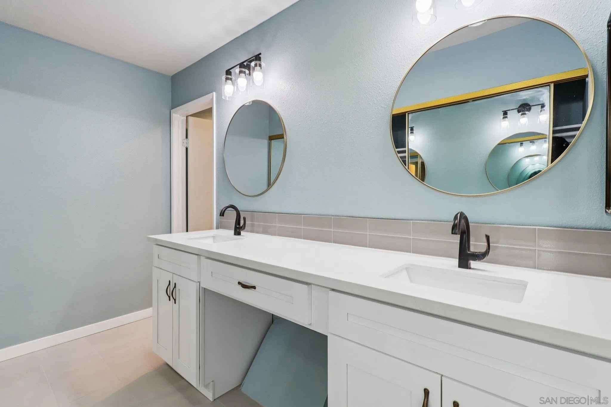 6329 Caminito Estrellado San Diego, CA 92120 - Photo 37 of 61 a bathroom with a sink and a mirror