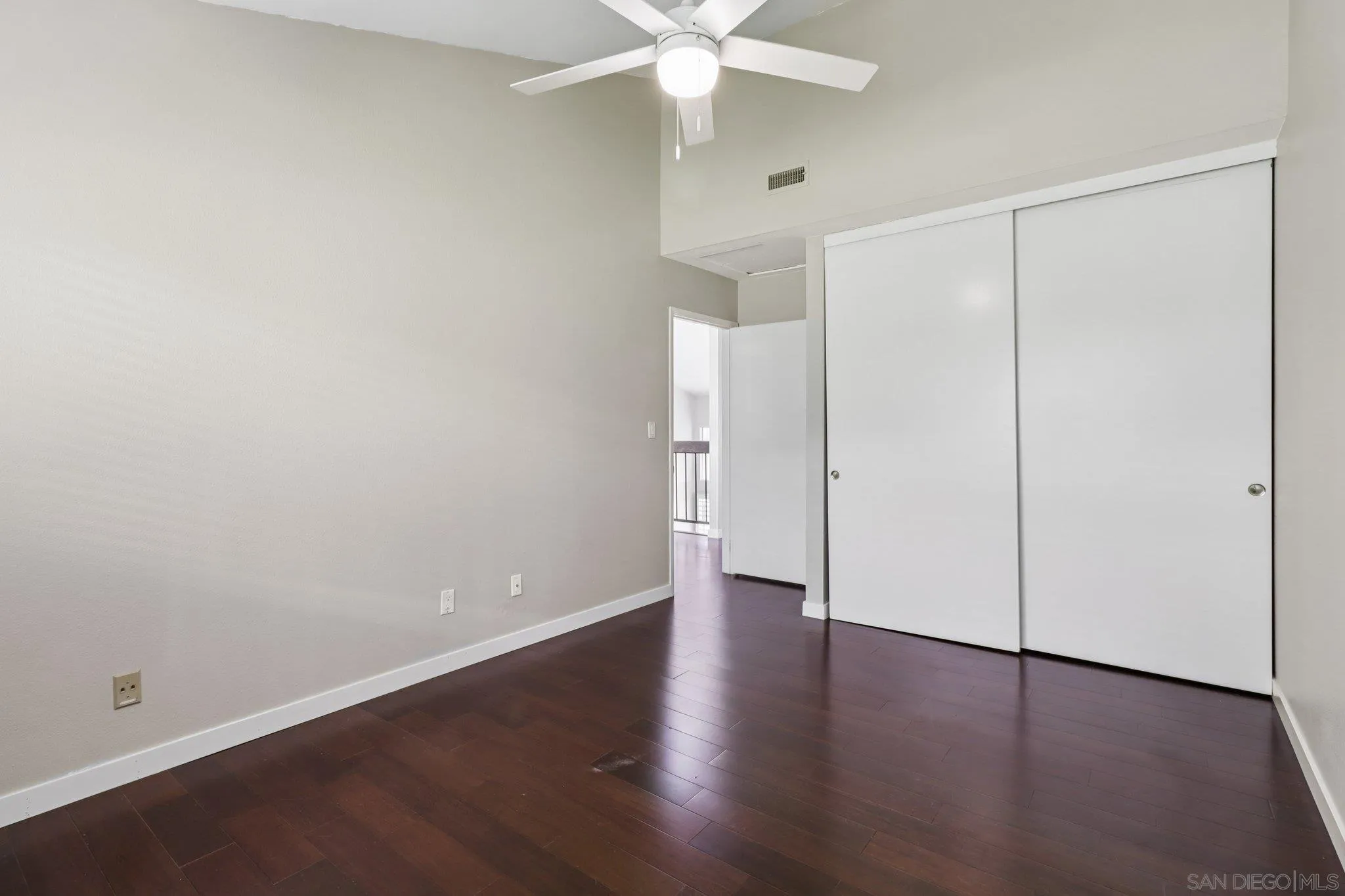 6329 Caminito Estrellado San Diego, CA 92120 - Photo 38 of 61 an empty room with wooden floor and a ceiling fan