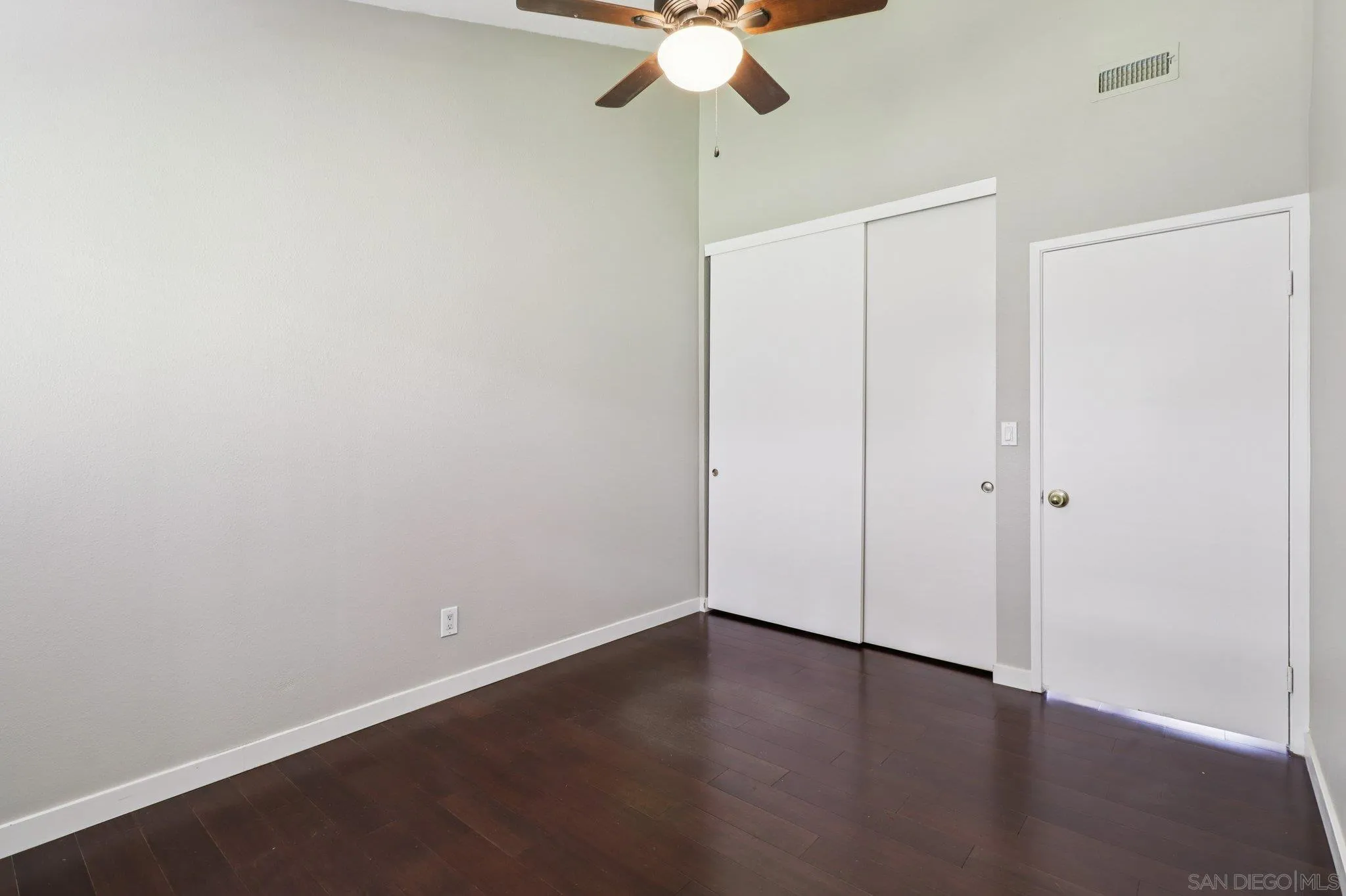 6329 Caminito Estrellado San Diego, CA 92120 - Photo 44 of 61 an empty room with a ceiling fan and wooden floor